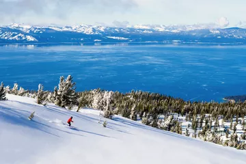 Skier at Heavenly Ski Resort with view of Lake Tahoe